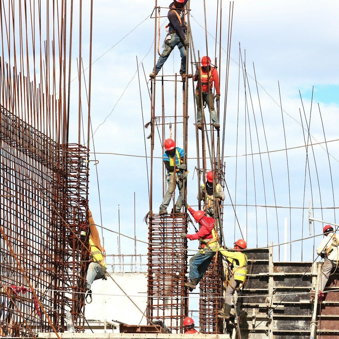 people working on building during daytime