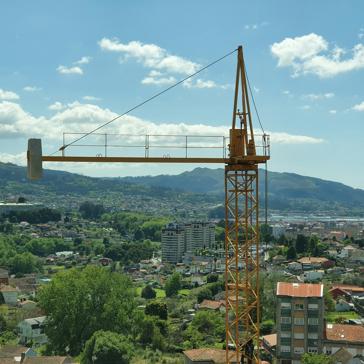 a crane is standing on top of a building